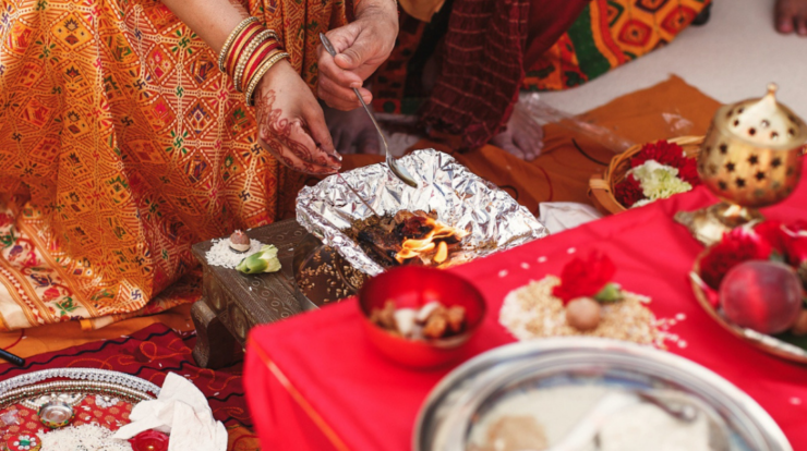 Devotees performing Lord Shiva puja and evening rituals during Guru Pradosh Vrat in a temple